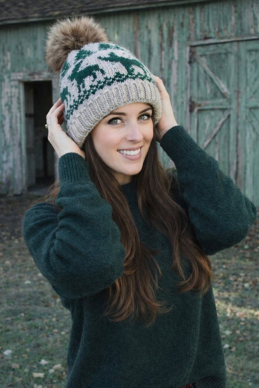 Women’s ISLEFIELD reindeer faux-fur pom hat, cozy winter accessory with festive reindeer and pom pom details.