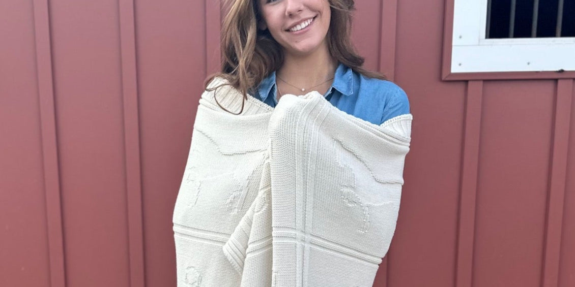 ISLEFIELD Cross Bit Throw blanket with geometric pattern, soft fabric, folded for display in natural lighting.
