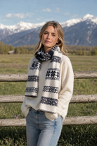 ISLEFIELD Flora scarf featuring vibrant floral patterns and soft fabric, displayed draped on a neutral background.