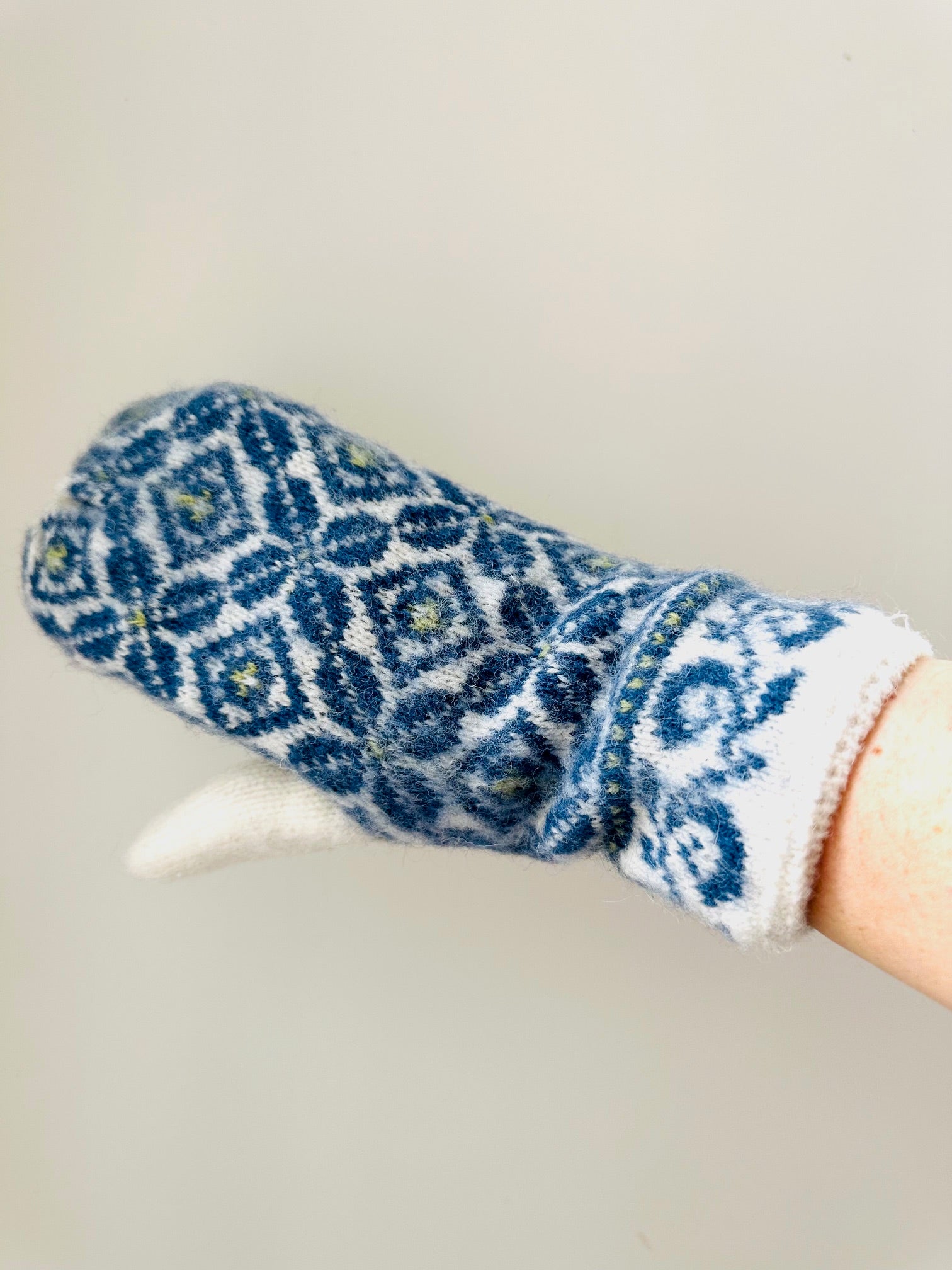 Blue ISLEFIELD Nordic mitten, cozy glove accessory with knitted design, ideal for cold weather warmth and style.